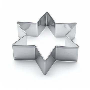 Shiny, metallic six-pointed star-shaped cookie cutter on a white surface, casting a shadow