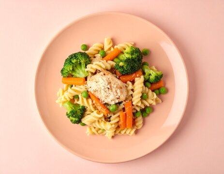 Delicious and healthy kids lunch with creamy chicken pasta and vegetables