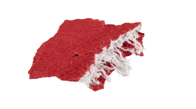 Torn red paper piece with ragged white fibrous edges isolated on transparent background