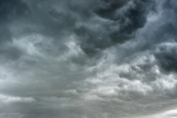 Obraz premium dark clouds sky black Heavy rain thunderstorm. Pattern overcast tornado Hurricane cyclone typhoon storm and rainy. Dark sky cloudy have storm lightning thunderbolt. Hole in Dark Dramatic Clouds
