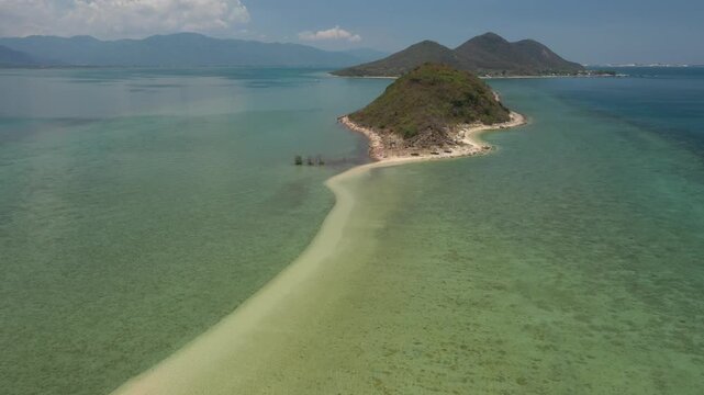 Aerial view of Diep Son Islands in Van Phong Bay, Van Thang Commune, Khanh Hoa, Vietnam, with a kayaker paddling through crystal-clear turquoise waters and scenic coastal landscapes.