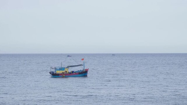 Colorful Vietnamese Wooden Fishing Boat Floating on Open Sea