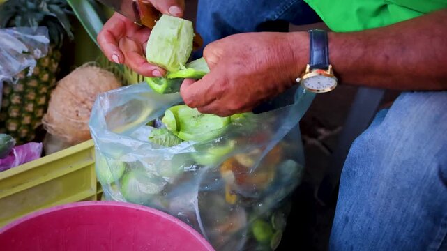 Man Peeling Cactus Pear Fruit At Fresh Market Pineapples Coconut Nearby