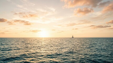 Obraz premium A sailboat glides across a calm ocean during a beautiful sunset. The sun is setting on the horizon, casting a warm glow over the water and sky.