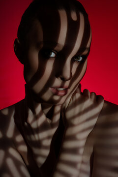 Striking beauty portrait highlighting shadows on the skin