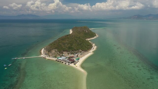 Aerial view of Diep Son Islands in Van Phong Bay, Van Thang Commune, Khanh Hoa, Vietnam, with a kayaker paddling through crystal-clear turquoise waters and scenic coastal landscapes.