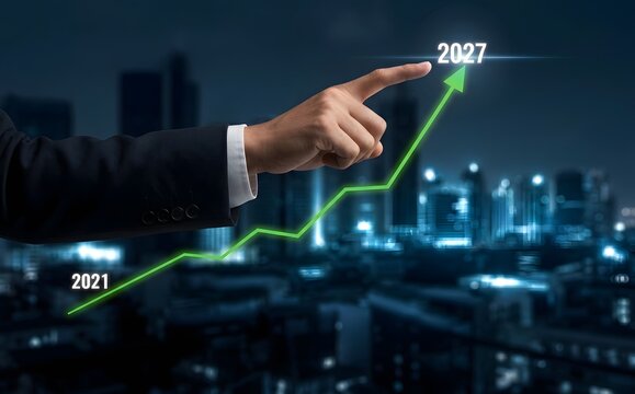 Businessman points at upward trending graph showing growth from 2021 to 2027
