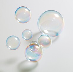 Obraz premium Colorful soap bubbles floating against white background