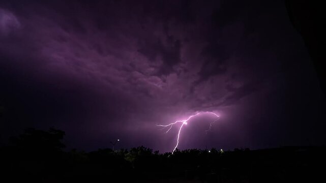 Lightning captured in slow motion illuminating the sky during a thunderstorm; a dramatic shot ideal for videos of atmospheric phenomena.