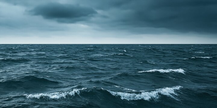 Dark stormy ocean waves under heavy grey clouds