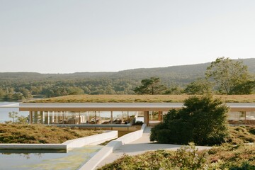 Fototapeta premium Sustainable resort building with a green planted roof and reflecting water channels, featuring raw concrete and glass for eco architecture and luxury travel