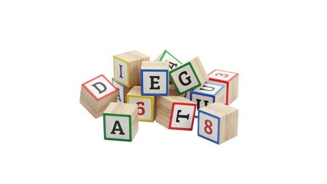A pile of wooden alphabet and number blocks with colorful borders isolated on a transparent background