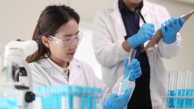 An Asian female scientist works with samples in a science laboratory.