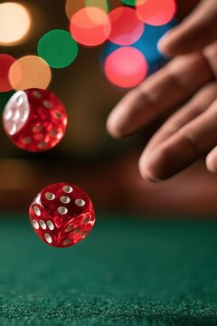 Red dice rolling on green felt table with