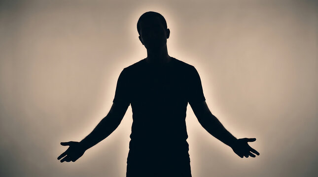 Man's silhouette in a backlit studio pose, expressing confusion and uncertainty over a difficult decision.