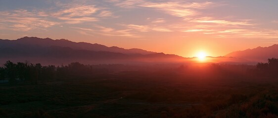 Obraz premium sunrise over misty mountains and valley landscape