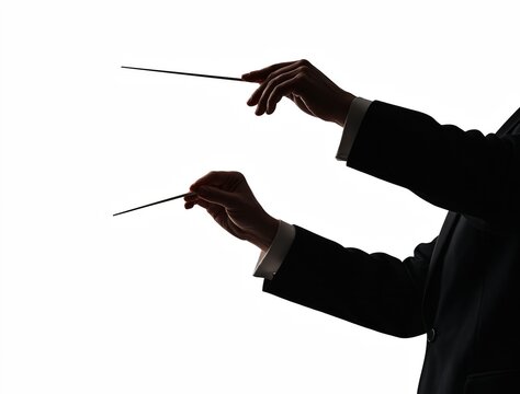 Silhouette of musician conducting orchestra with batons