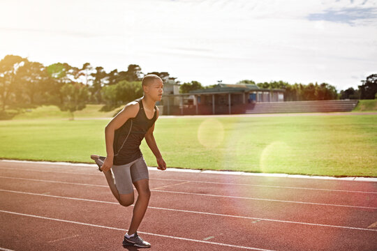Teenager, boy and running on track with fitness, cardio training and practice for school athletics. Student, athlete and runner outdoor with speed exercise, sprint and workout at sports academy.