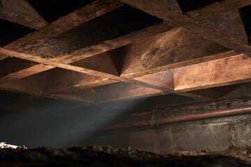 Fototapeta premium Old wooden beams with light in dark basement