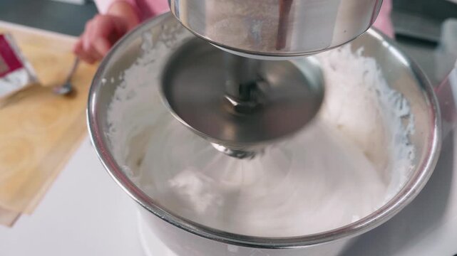 Whipping meringue in a stand mixer for French macaron preparation