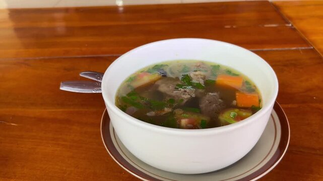 Indonesian Traditional Beef Vegetable Soup Sop Daging Served in White Bowl on Wooden Table⁠