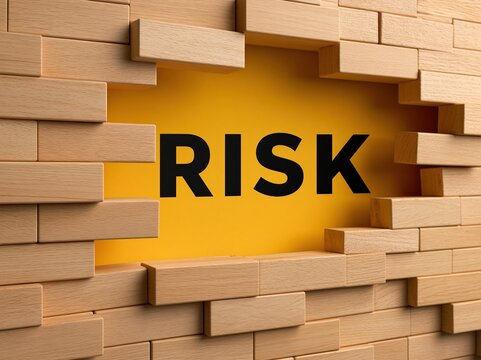 Wooden blocks forming wall with risk word behind
