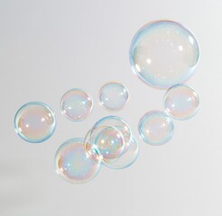 Obraz premium Colorful soap bubbles floating against white background