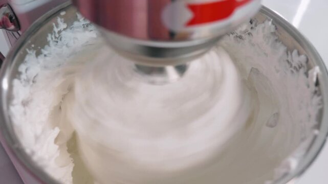 Whipping meringue in a stand mixer for French macaron preparation