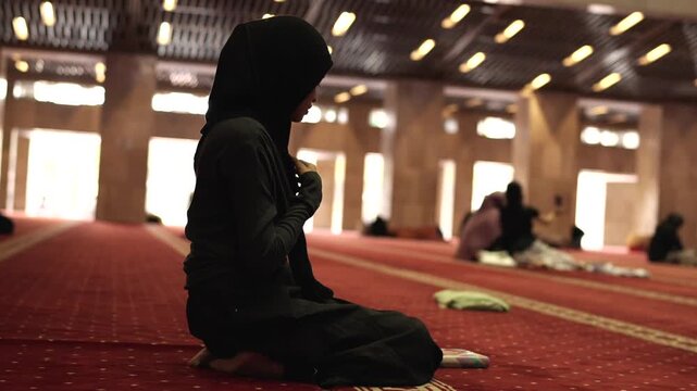 Muslim woman praying in a mosque