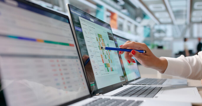 Young Woman Examines Software Change Request On Laptop