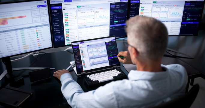 Software Developer Closely Watches API Traffic On Laptop