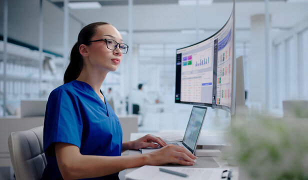 Hospital Manager Tracks Patient Flow Data Using Laptop