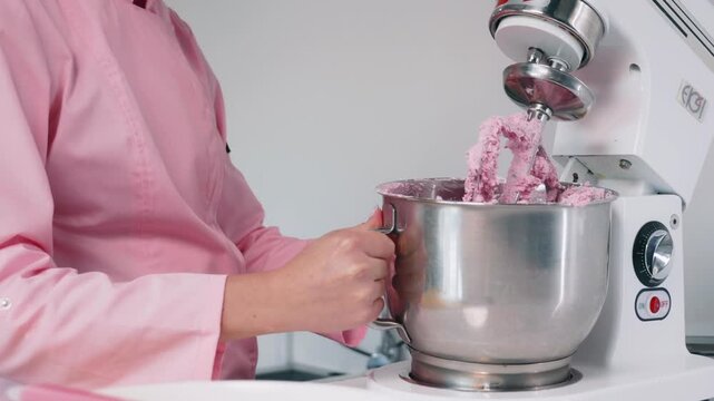Removing pink macaron mixture from a stand mixer