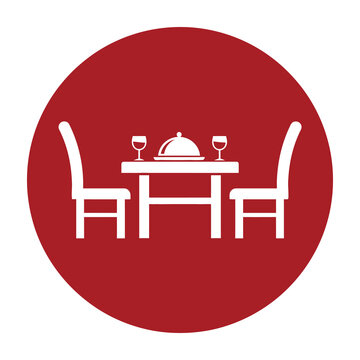Table setting with two chairs wine glasses and covered dish on red background