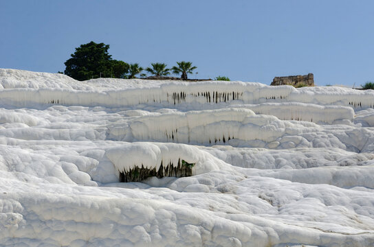 Pamukkale Turkey travertine terraces white mineral formations thermal springs ancient landscape blue sky natural wonder tourism destination geology calcium pools