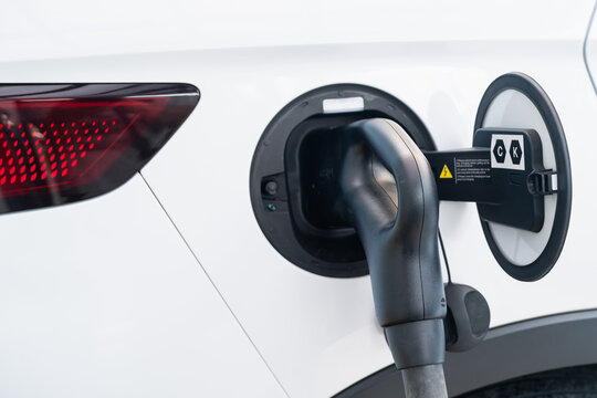 4K slow motion person charging electric car at Charger station.	
