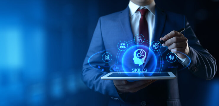 Businessman holding tablet with Skills icons on screen - Education and E-Learning Concept