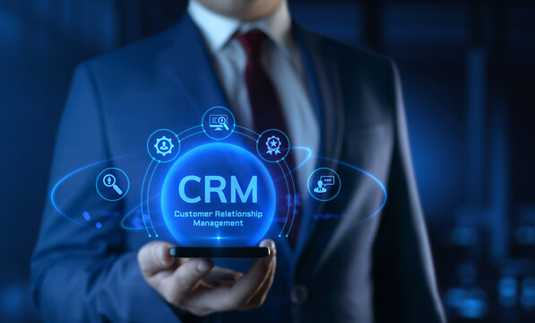 Businessman holding smartphone with CRM Customer Relationship Management icons on screen