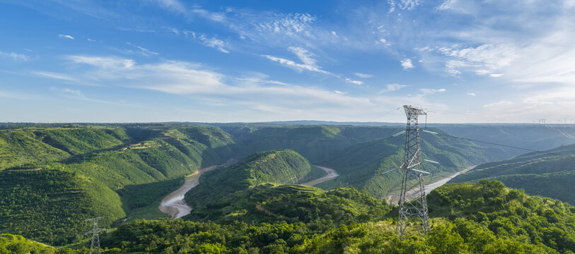 Electricity Pylon Over Winding River Valley