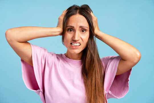 Woman feeling frustrated and stressed, pulling hair