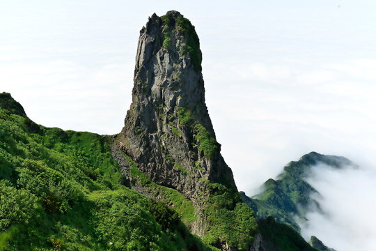 Mount Rishiri rugged rock peak above sea of clouds Hokkaido