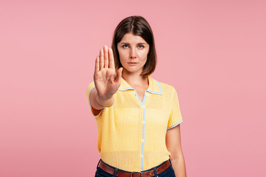 Woman making stop gesture expressing denial and boundaries