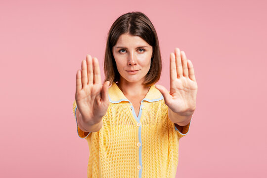 Woman making stop gesture expressing denial and refusal