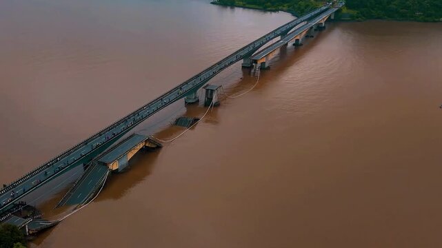 Aerial view of a bridge collapsed by river flooding.