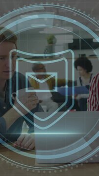 Animation of cyber security text, envelope icon, caucasian coworker discussing over laptop in office