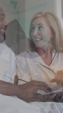 Animation of statistical data processing over happy couple using laptop in the bed at home