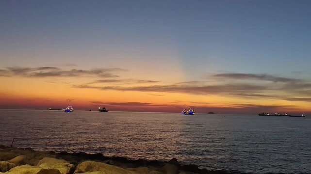 Peaceful Ocean Sunset with Boats on the Horizon