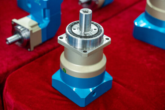 Precision planetary gear reducer device displayed on red velvet surface