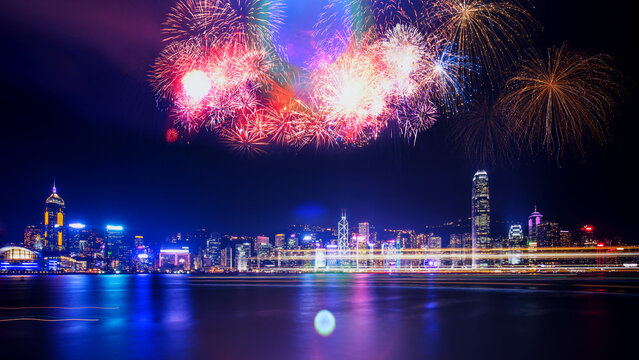 Spectacular night fireworks display over a vibrant city skyline