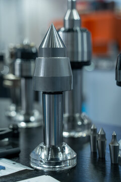 Metal precision machining lathe tool parts displayed on workbench